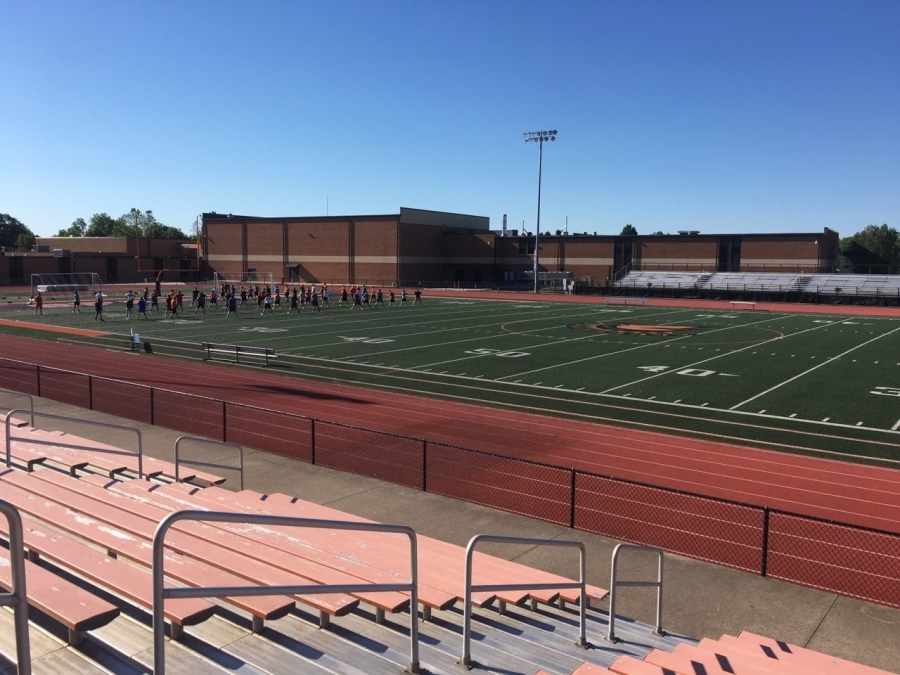 image of people on a track and field